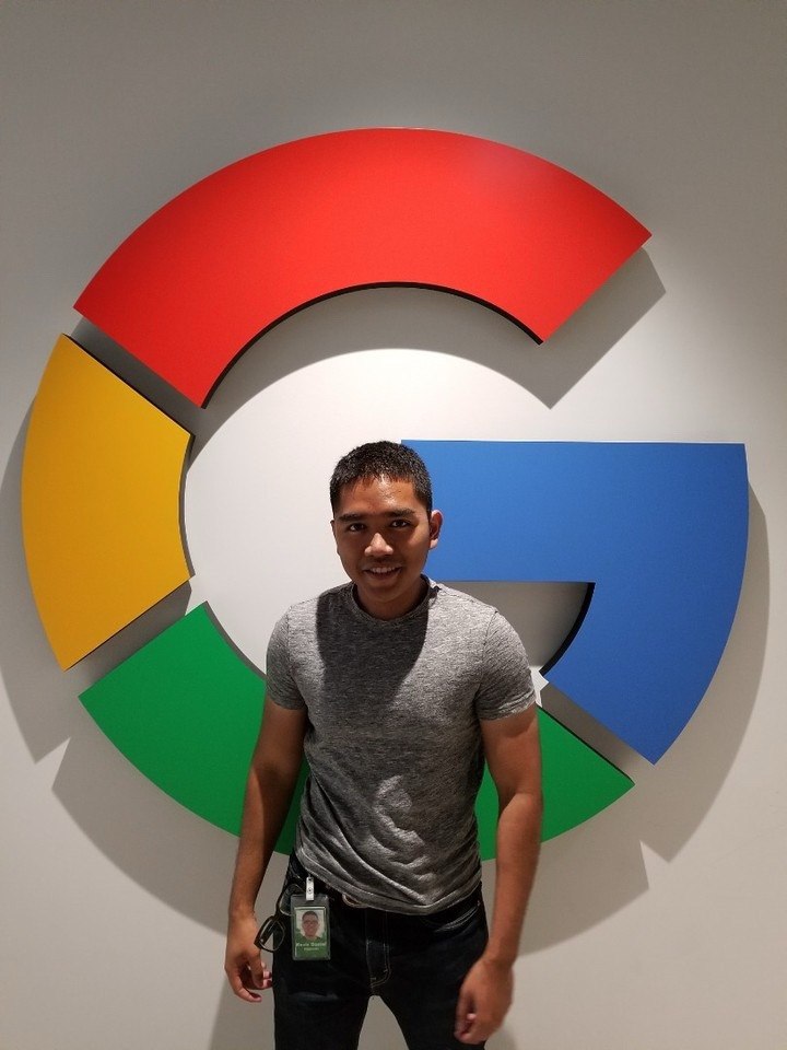 Kevin standing in front of the Google logo